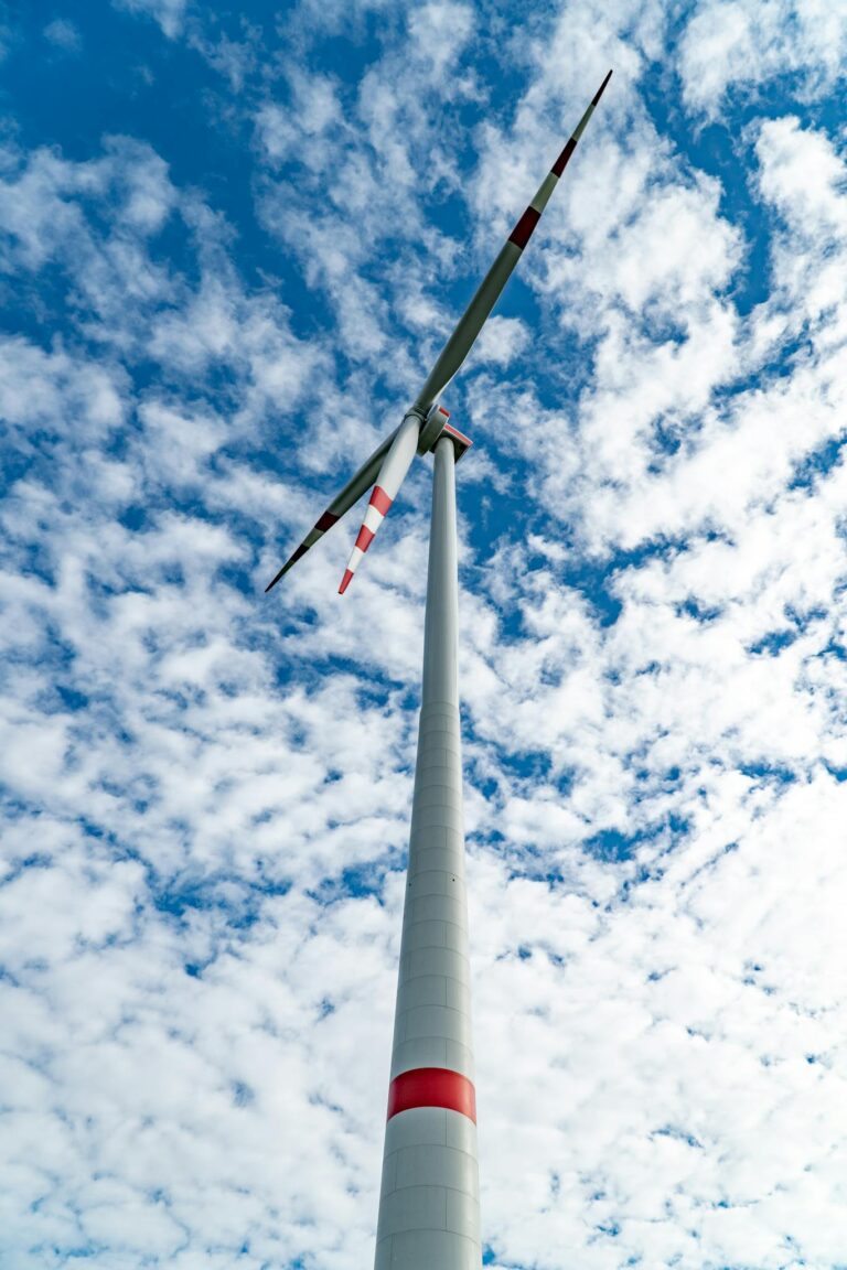A towering wind turbine against a clear blue sky in Austria, showcasing renewable energy.